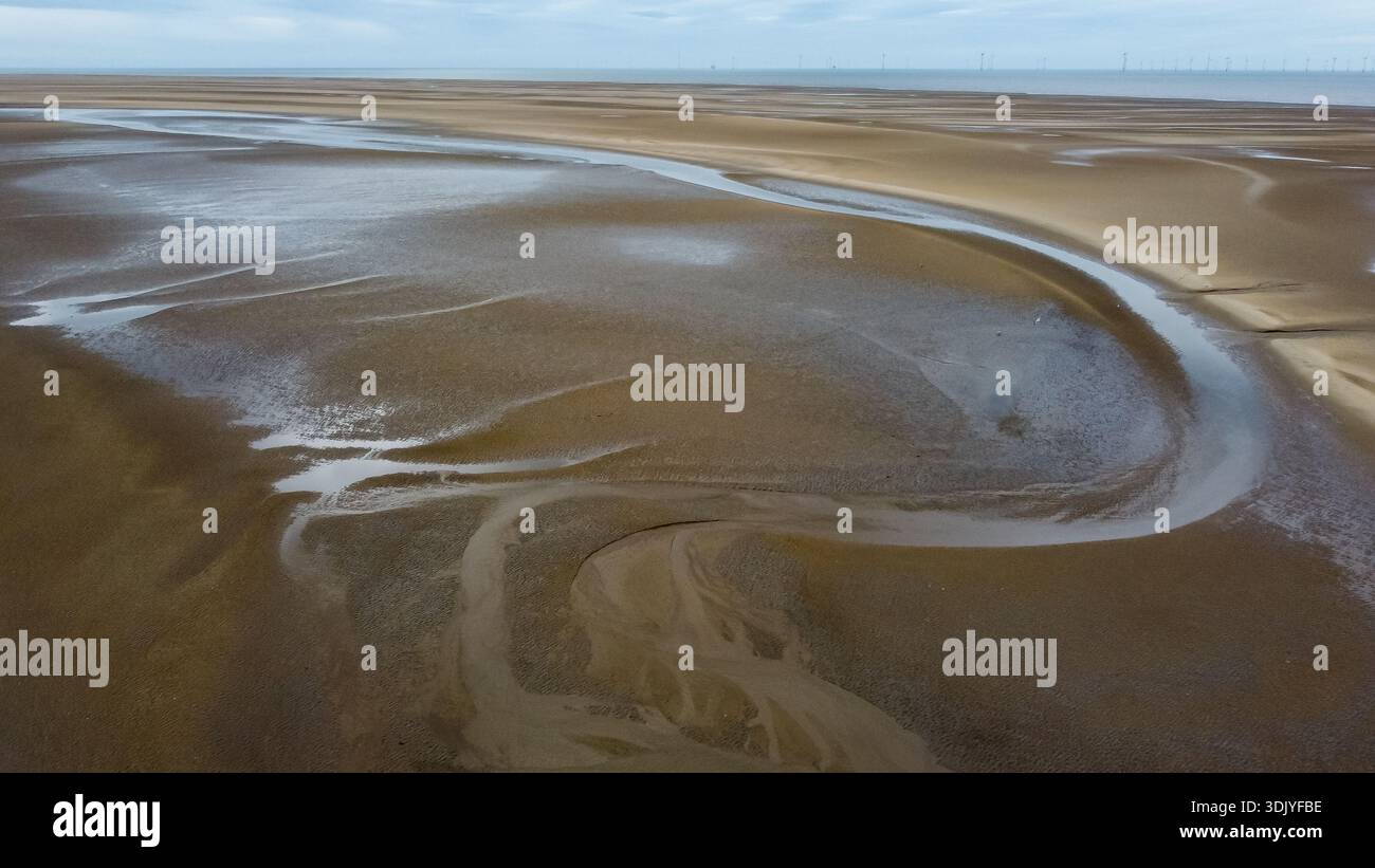 Vue aérienne des chenaux de marée et des modèles abstraits de drainage de l'eau sur le sable Banque D'Images