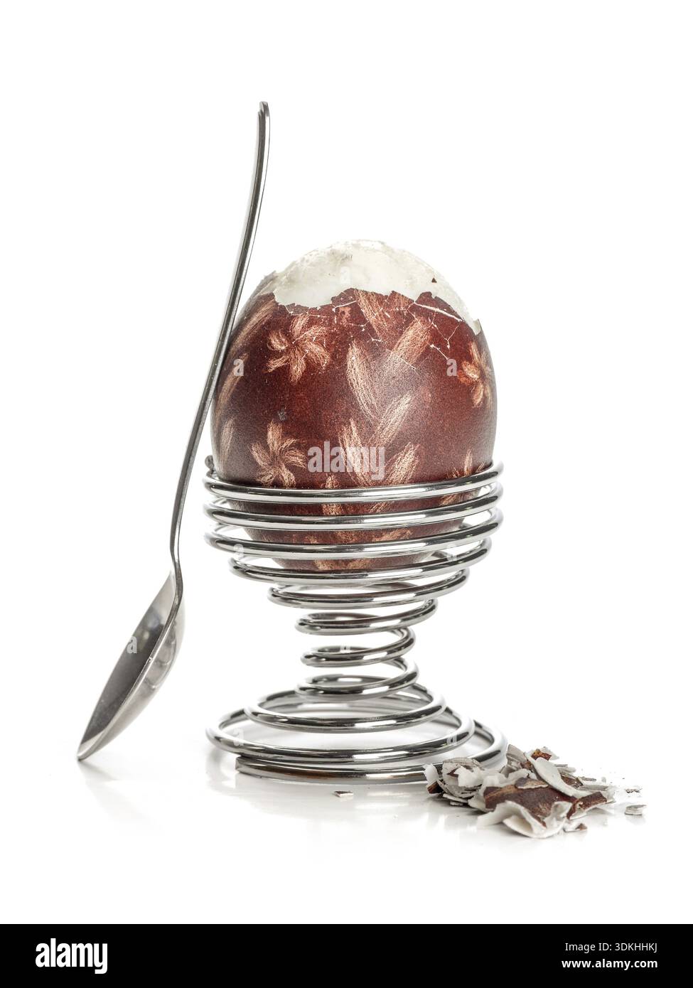 Oeufs à la coque avec des oeufs de Pâques ornement-shell dans un stand en spirale avec tee-spoon prêt pour le petit-déjeuner tourné sur fond blanc Banque D'Images