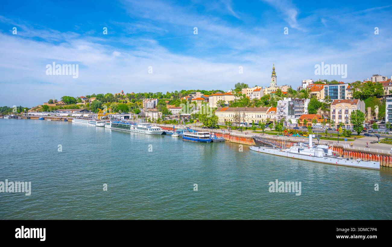 La Sava traverse Belgrade, et présente des bâtiments dynamiques et une végétation luxuriante le long des rives. Les bateaux sont amarrés, et l'horizon révèle un mélange d'histoire et de modernité. Banque D'Images
