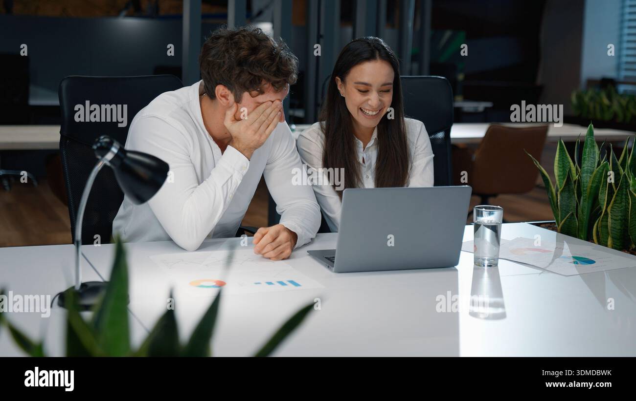Joyeux gestionnaires d'entreprise caucasiens parlant sourire riant avec ordinateur portable partenariat réussi dans l'homme d'affaires de la société avec femme d'affaires parler rire Banque D'Images
