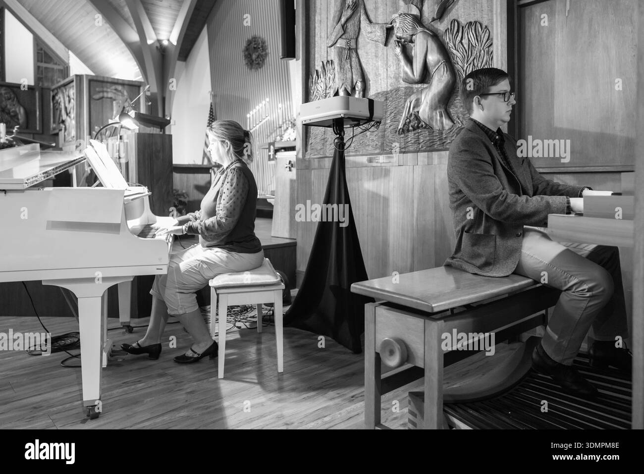 Des musiciens se produisent pendant le service de la veille de Noël à l'église congrégationnelle de Waiokeola à Honolulu, Hawaï. Une femme joue du piano tandis qu'un homme opère Banque D'Images
