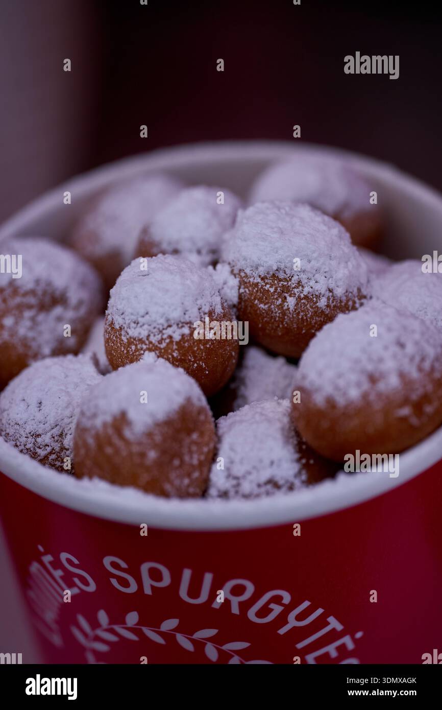 Les beignets ou beignets sont fabriqués à partir d'un mélange de farine, de sucre, de jaunes d'oeufs, de levure et de beurre. Sucre en poudre en forme de boule sur un beignet empilé Banque D'Images