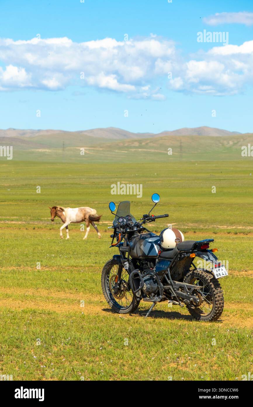 Mongolie, province bulgare, région de Dashinchilen, cheval et moto Royal Enfield Himalayan 400 Banque D'Images