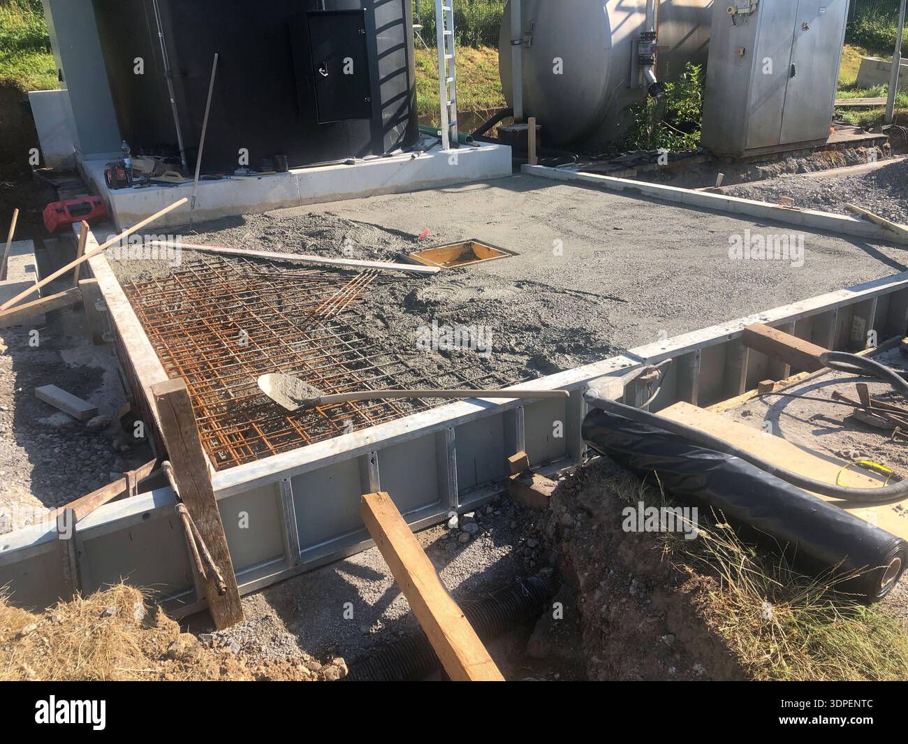 La plaque de base pour le ravitaillement en carburant d'un réservoir de stockage est bétonnée Banque D'Images