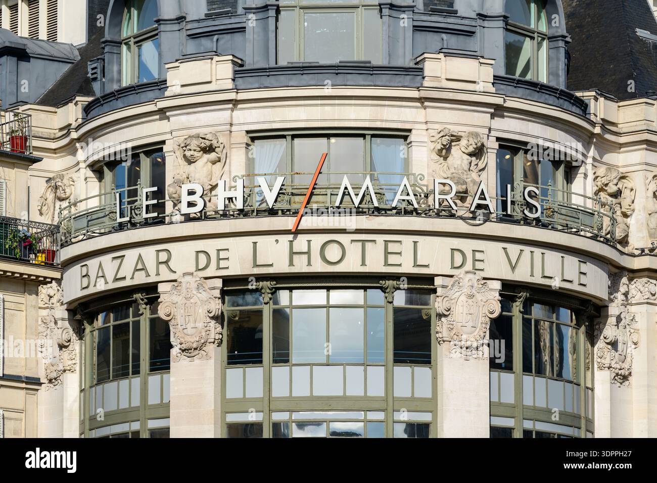 Paris, France - 27 avril 2022 : la façade du grand magasin le BHV Marais est visible, avec des enseignes bien en vue indiquant « LE BHV/MARAIS » et « BAZAR DE L'HÔTEL DE VILLE », avec des sculptures en pierre décoratives et de grandes fenêtres cintrées. Banque D'Images