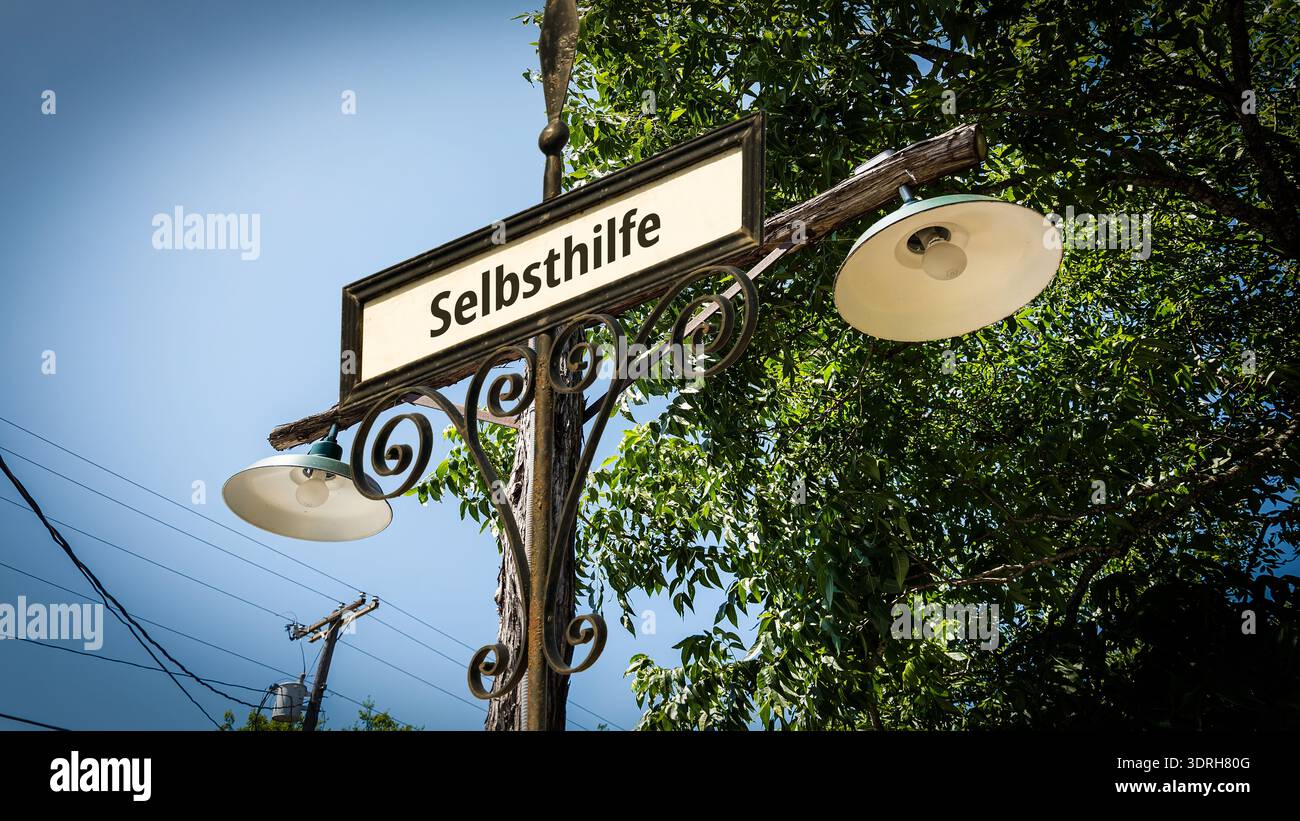 Une image avec un panneau en allemand pointant dans la direction de l'auto-assistance. Banque D'Images