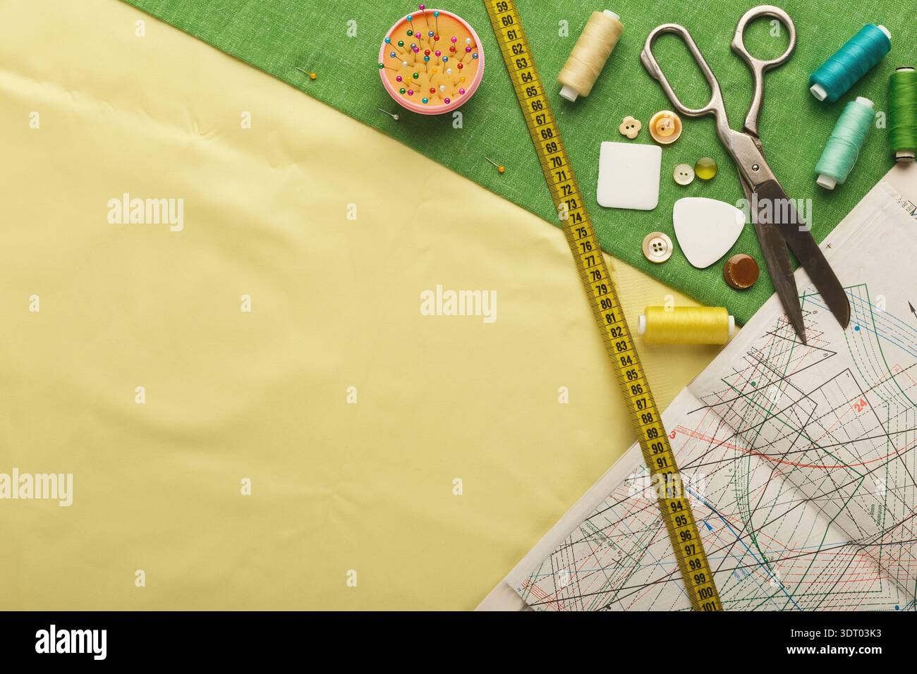 Collection d'outils de couture et de matériaux pour l'artisanat affichés sur un espace de travail Banque D'Images