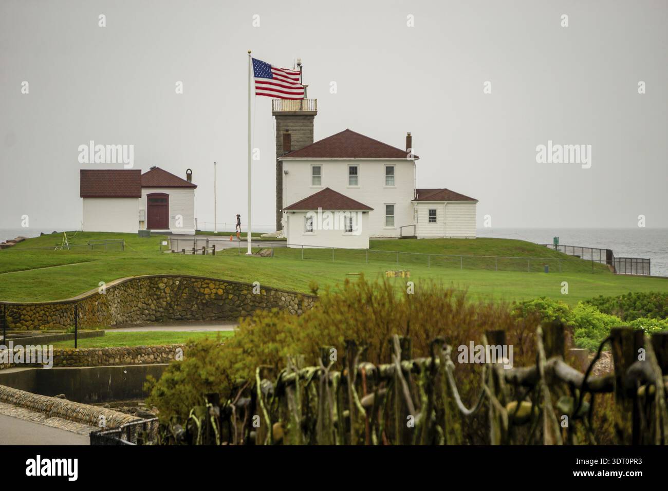 Admirez Hill Light dans le Rhode Island entouré d'une digue en pierre Banque D'Images