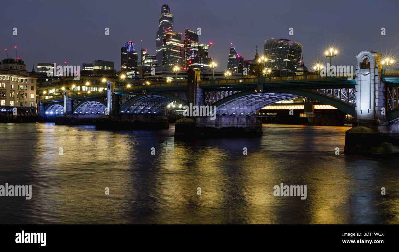 La vue nocturne sur les gratte-ciels de Londres présente des gratte-ciels illuminés qui se reflètent sur la Tamise, avec une architecture proéminente et un cit dynamique Banque D'Images