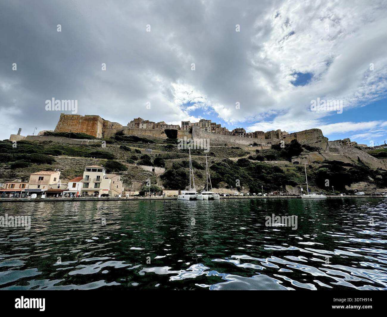 Port et centre ville de Bonifacio sur la pointe sud de la côte méditerranéenne Corse, photographiés depuis l'eau en été. Banque D'Images