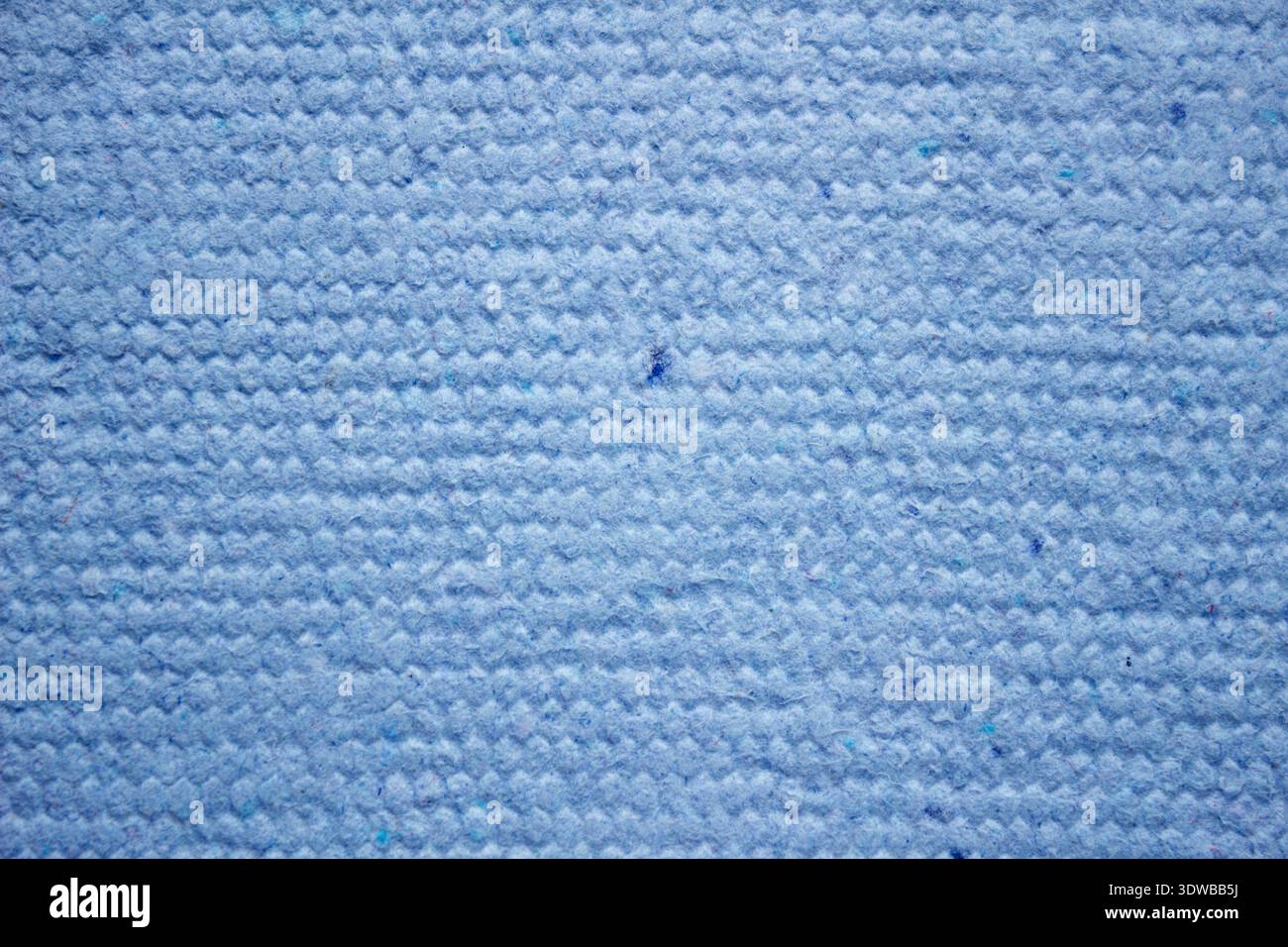 Un fond en papier bleu texturé fait à la main fabriqué à partir de matériaux recyclés, offrant un design unique et respectueux de l'environnement. La surface montre des fibres complexes Banque D'Images