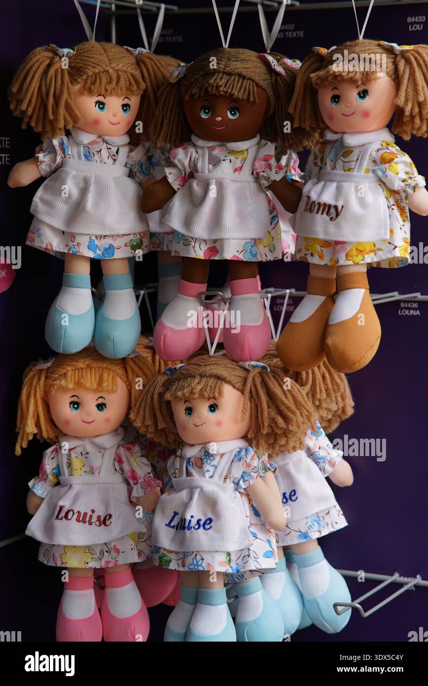 Adorables poupées de chiffon faites à la main avec des cheveux tressés et des noms personnalisés comme 'Louise' accroché dans un magasin de souvenirs coloré display.Menton, France Banque D'Images