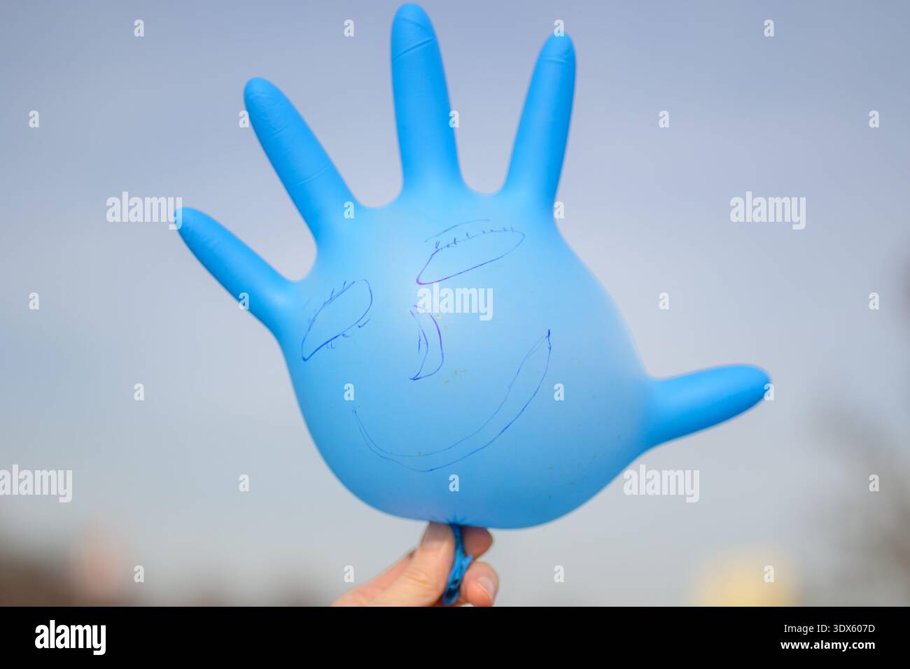 Blue Glove Balloon avec Smiley Banque D'Images