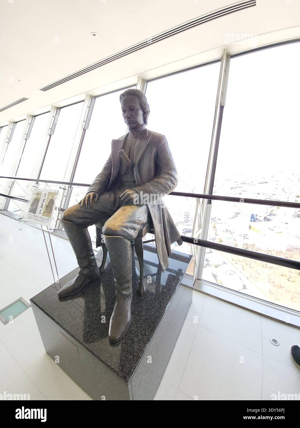 Une statue en bronze assise de Toshizo Hijikata, célèbre samouraï et vice-commandant de la force de police du Shinsengumi pendant la fin du shogunat Tokugawa. La statue honore le lien de Hijikata avec Hakodate, où il a passé ses derniers jours pendant la guerre de Boshin. Il est exposé sur la terrasse d'observation de la Tour Goryokaku, offrant aux visiteurs une vue sur le fort historique de Goryokaku en contrebas. Japon. Banque D'Images