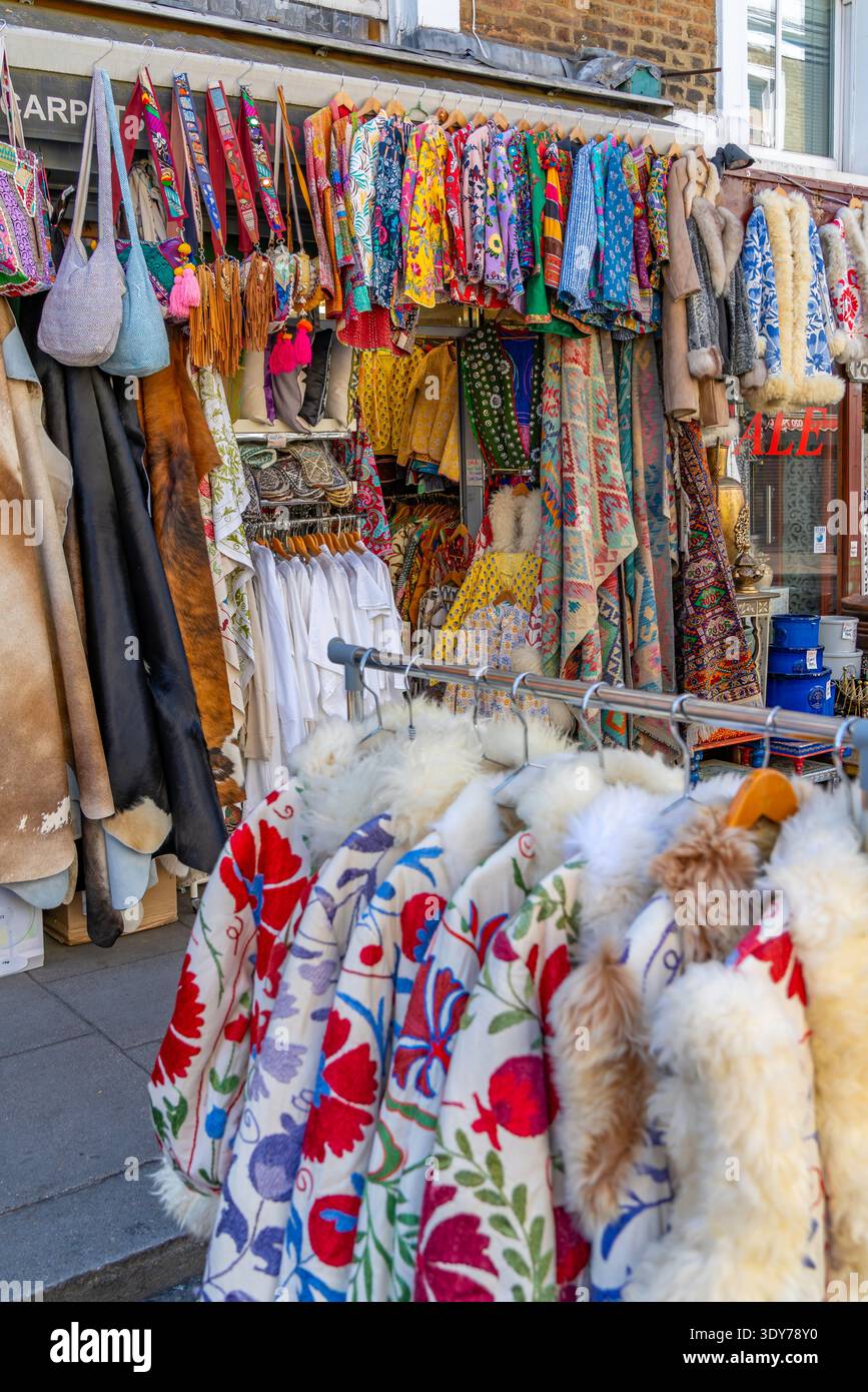 Textiles et vêtements colorés exposés dans une boutique d'été sur Portobello Road présentant la culture et le style londoniens à Kensington Banque D'Images