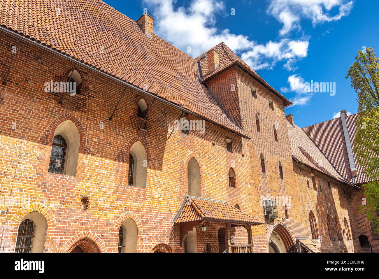 Le château de Malbork, un château gothique en briques dans le nord de la Pologne, en Europe. Majestueuse façade médiévale de château avec briques rouges, fenêtres cintrées, et Banque D'Images