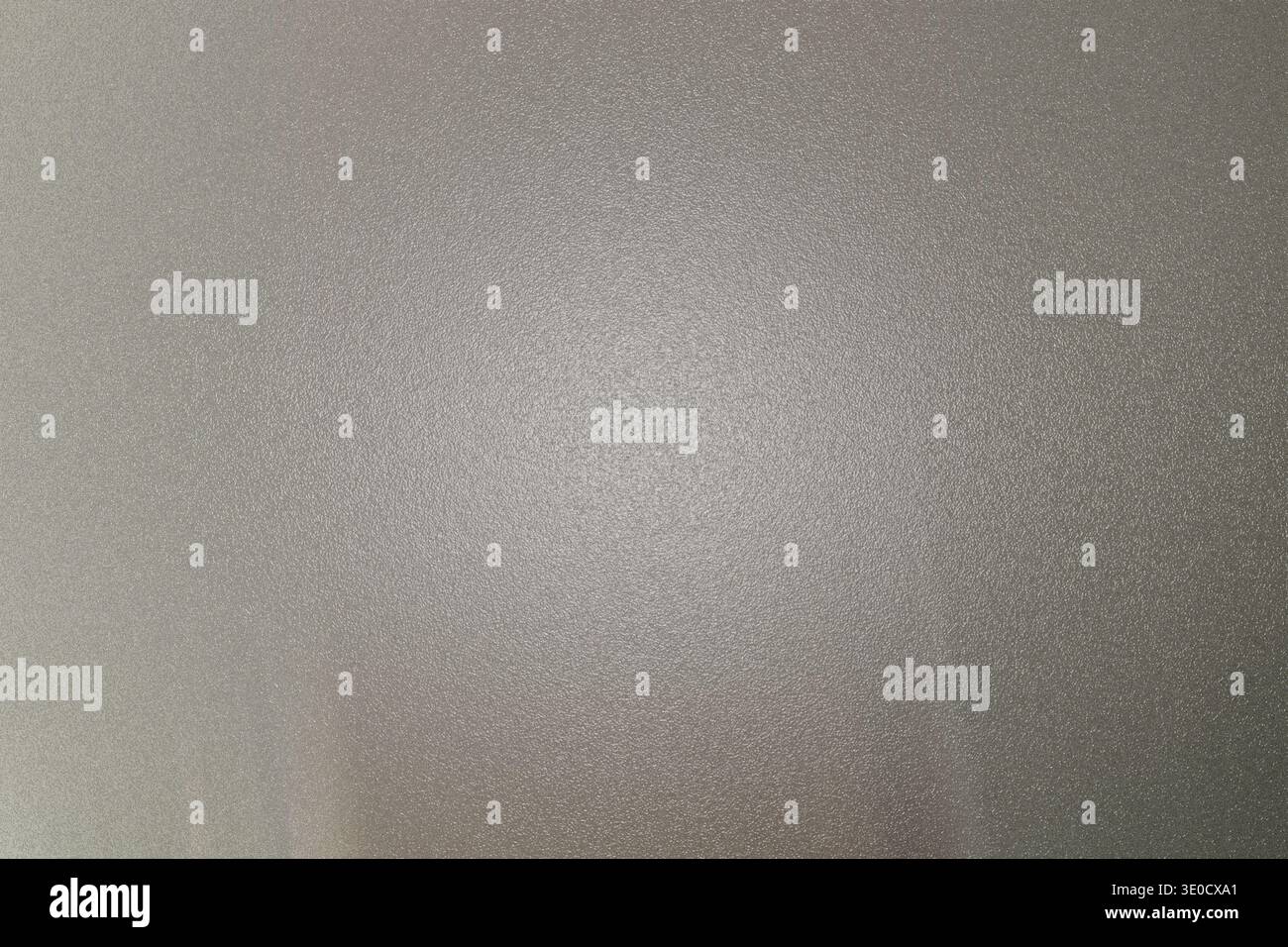 L'image montre une photographie floue et floue d'une surface gris clair ou blanc cassé. La texture est indistincte, et il n'y a pas de discernement Banque D'Images