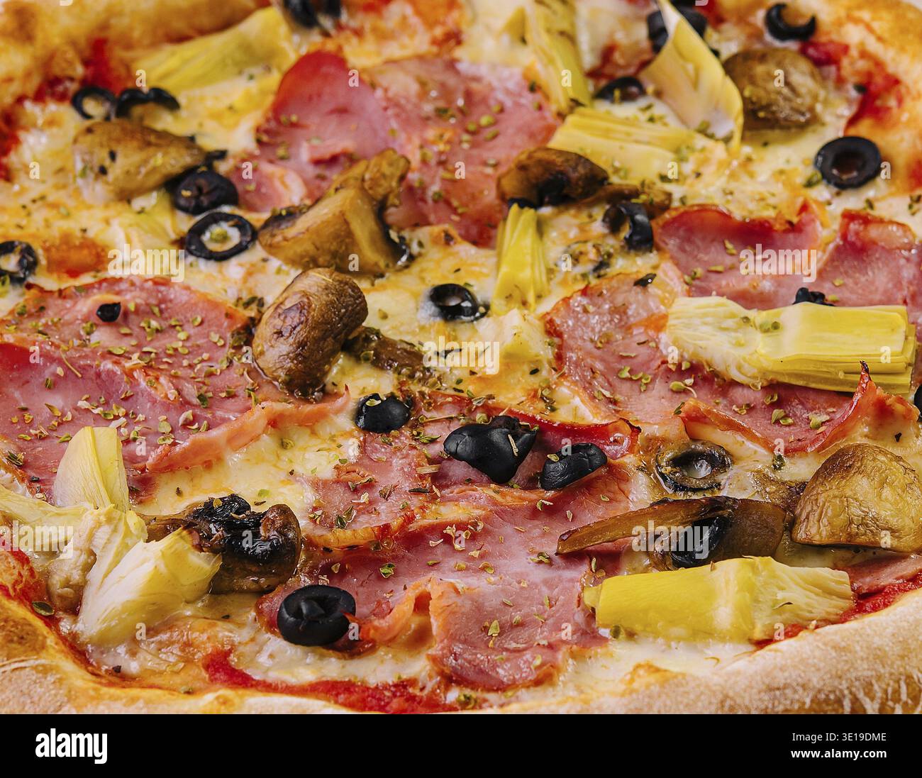 Pizza suprême fraîchement cuite garnie de divers ingrédients gros plan Banque D'Images