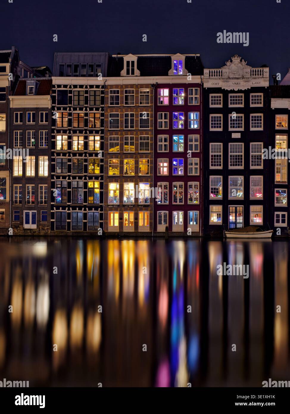 Les maisons Damrak à Amsterdam, aux pays-Bas, créant un kaléidoscope de couleurs et de reflets vibrants. Banque D'Images