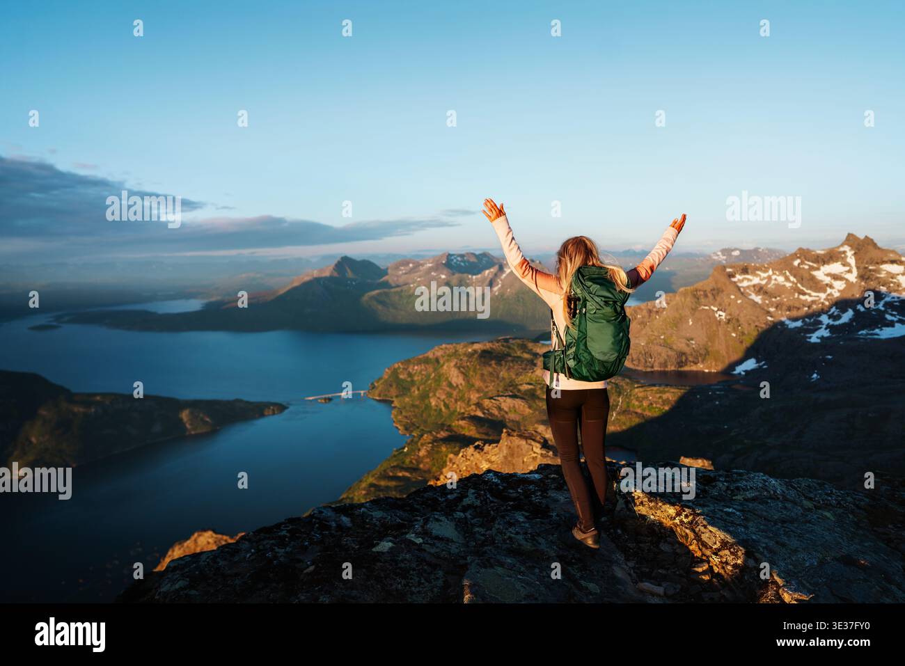 Femme vacancier voyage en solo en Norvège fille active avec sac à dos sur le sommet de la montagne a levé les mains profitant du voyage de randonnée dans la nature, vacances d'été en t Banque D'Images