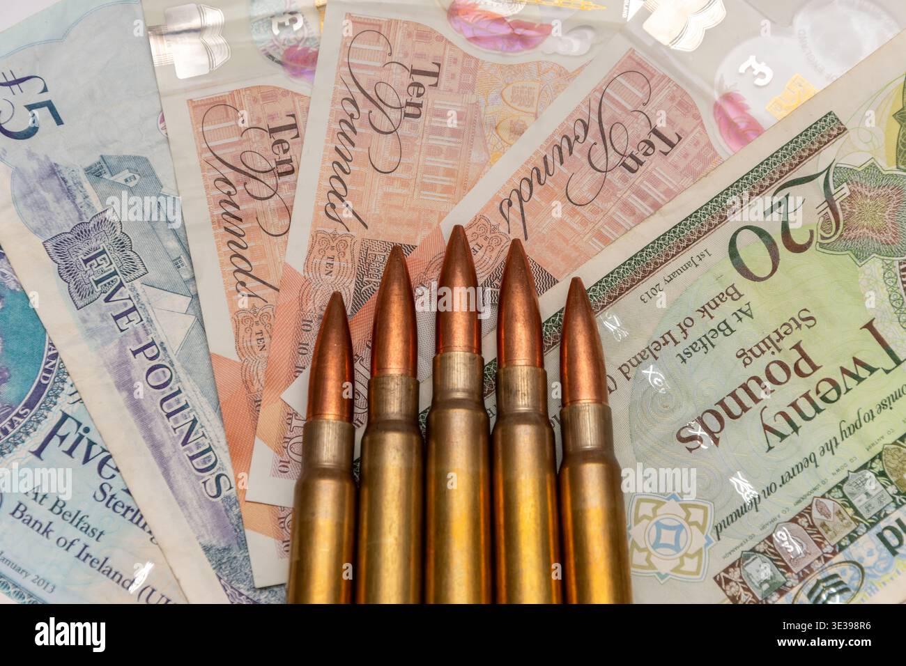 Rangée de cartouches sur livre sterling montrant les dépenses militaires et les risques financiers. Banque D'Images