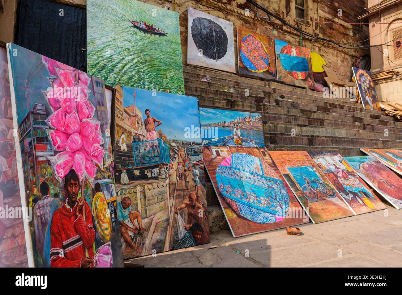 De nombreuses peintures colorées sur toile sont exposées à la vente sur les marches de pierre du Varanasi Dashashwamedh Ghat près du bord du Gange. Banque D'Images