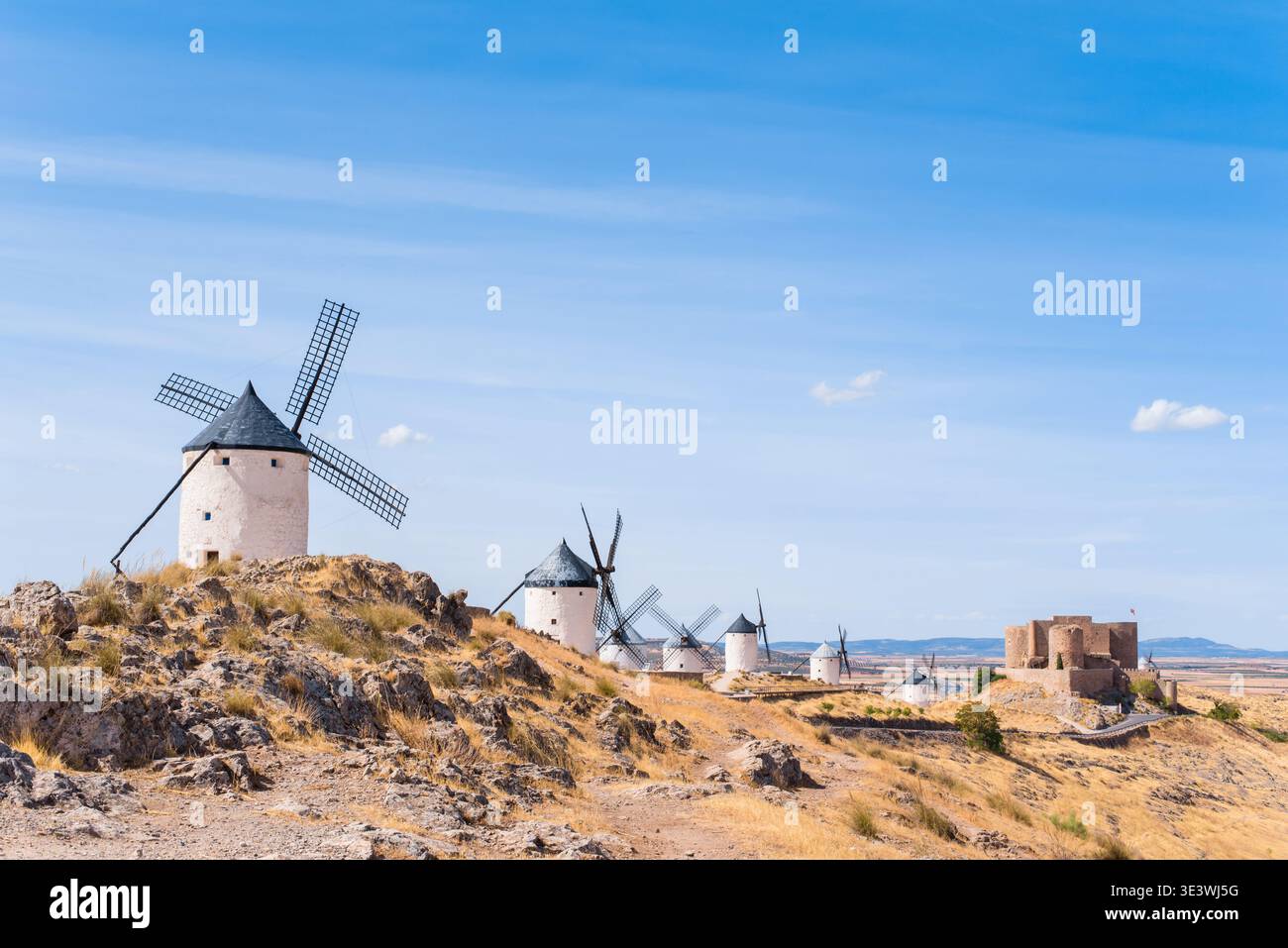 Vue panoramique des moulins à vent historiques à Consuegra, la Mancha, Espagne, sous un ciel bleu vibrant. Ces structures emblématiques illustrent l'arche espagnole traditionnelle Banque D'Images