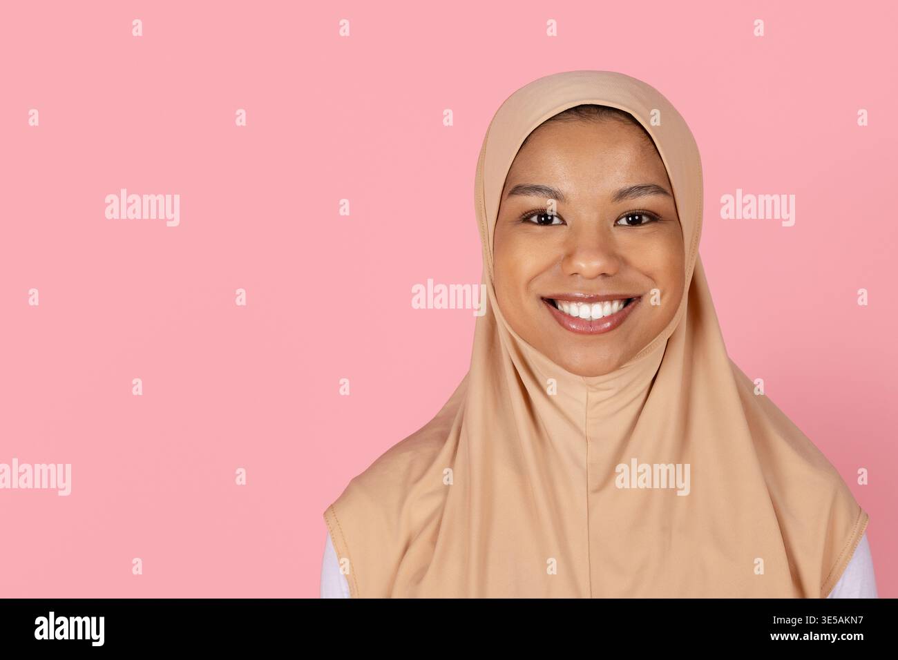 Gros plan portrait d'une jeune femme musulmane noire en hijab beige souriant naturellement Banque D'Images