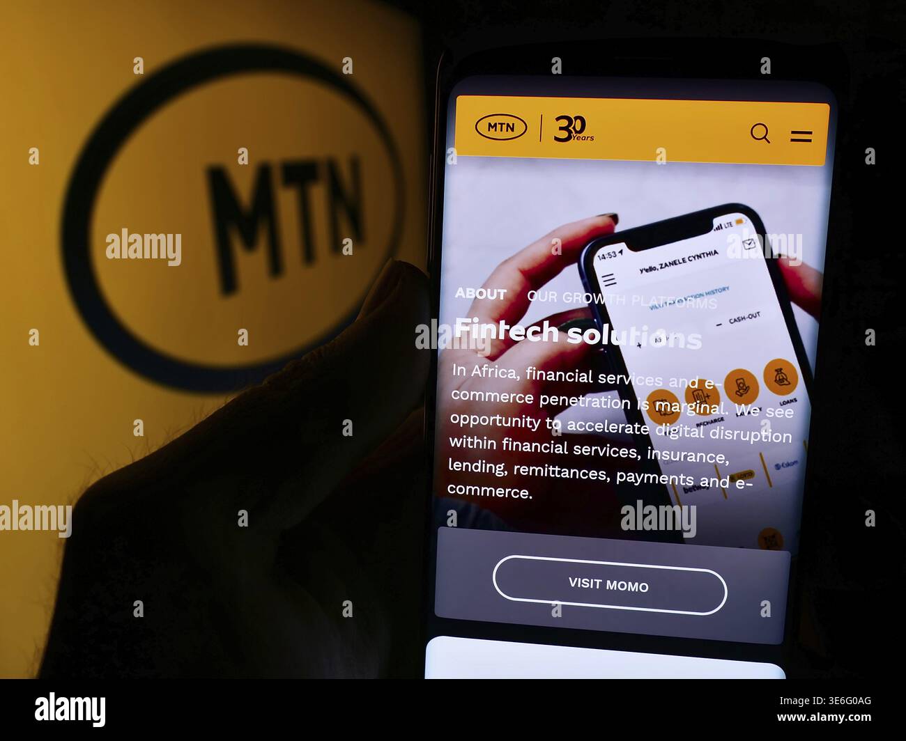Stuttgart, Allemagne - 08-07-2024 : personne tenant un smartphone avec la page web de la société sud-africaine de télécommunications MTN Group Limited avec le logo. Mise au point Banque D'Images