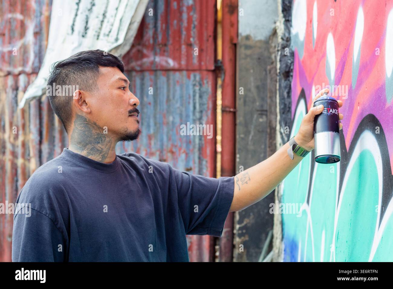 Makoyhamoy, artiste de rue de Cebuano, travaille sur son œuvre d'art sur un mur dans la ville de Cebu Banque D'Images