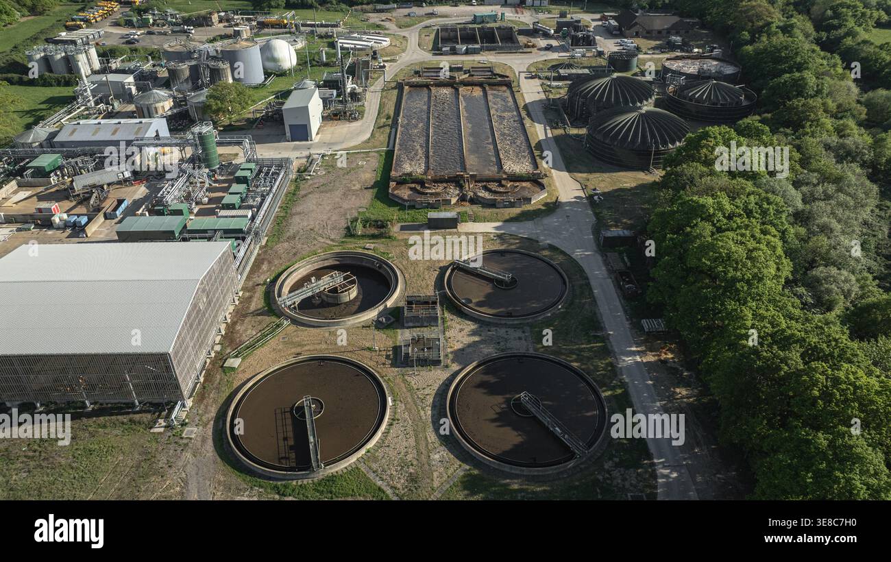 Une vue aérienne révèle une vaste usine de traitement des eaux usées avec de grands réservoirs distinctifs et diverses unités de traitement. Cette installation est conçue pour Banque D'Images
