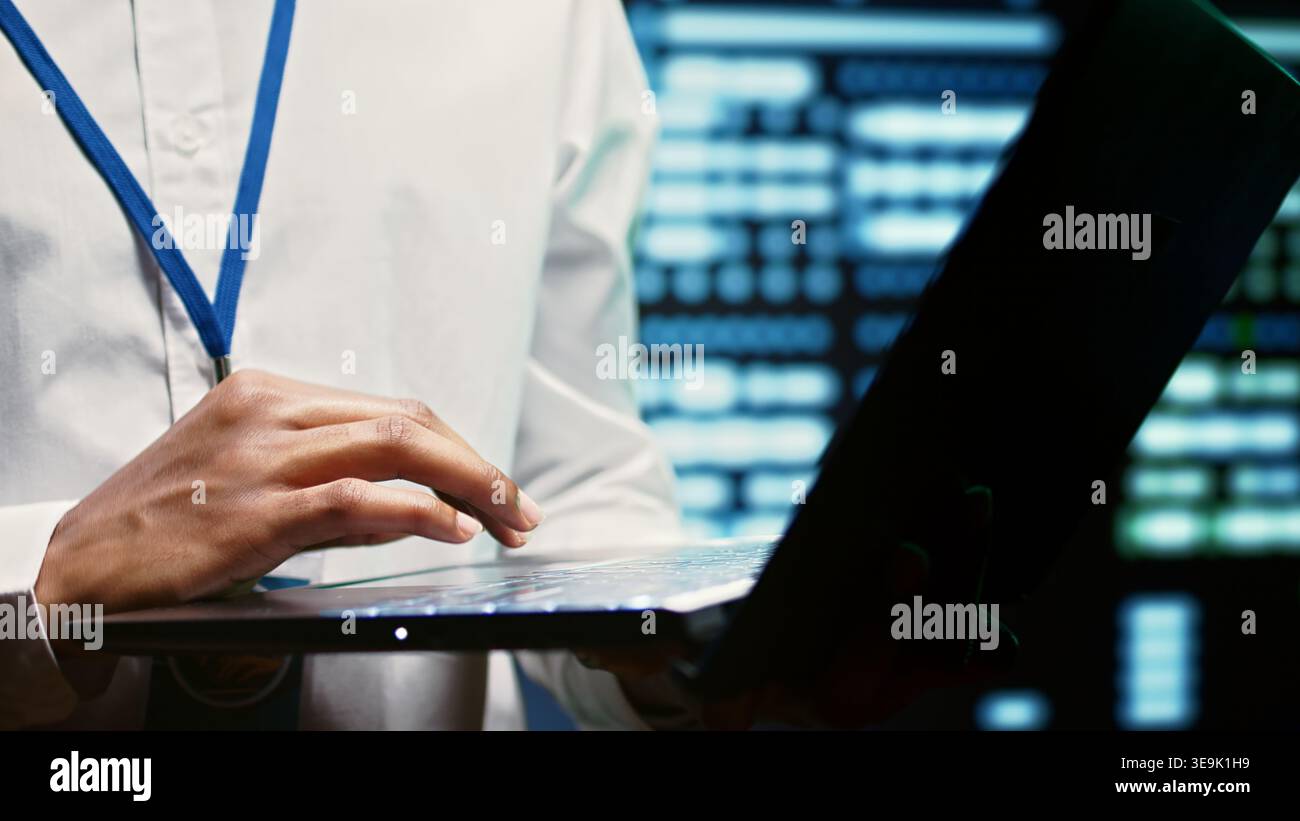 Ingénieur dans le centre de données parcourant les racks de serveurs utilisés pour les tâches de calcul intensif telles que la mécanique quantique ou les prévisions météorologiques. Expert exécutant le diagnostic de routine de l'équipement, gros plan Banque D'Images