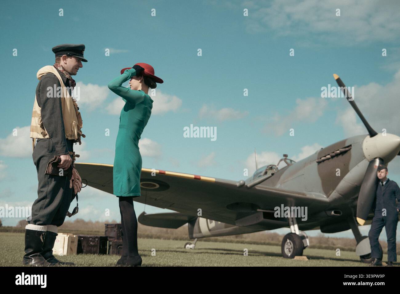 Le pilote de la RAF discute avec une femme en robe verte à côté du Spitfire MkVc EE602 à l'aérodrome de Sywell, Battle of Britain reconstitument. Banque D'Images