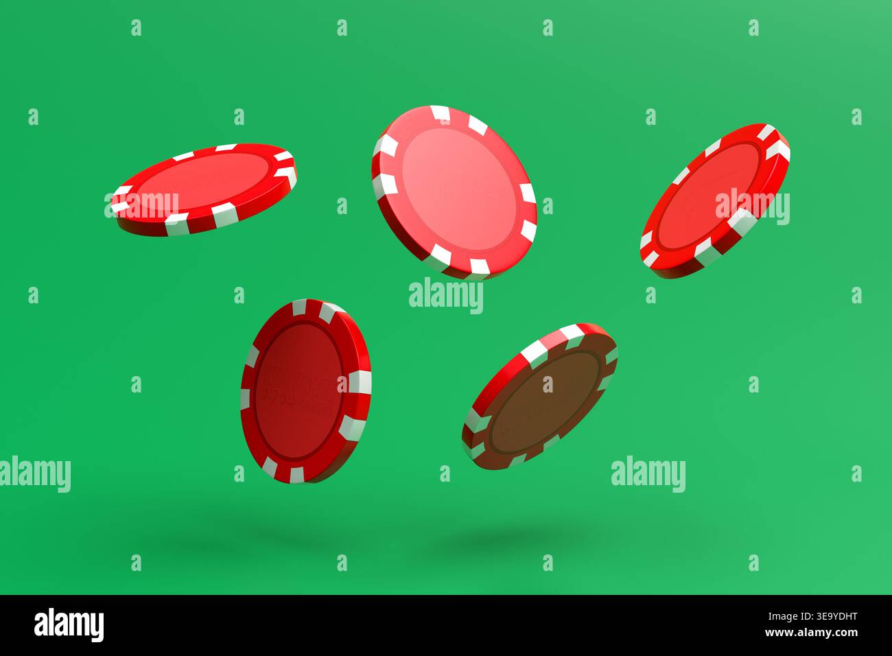 Jetons de jeu rouges, avec des rayures blanches, tombant sur un fond vert éclatant, créant un concept de jeu et gagnant Banque D'Images