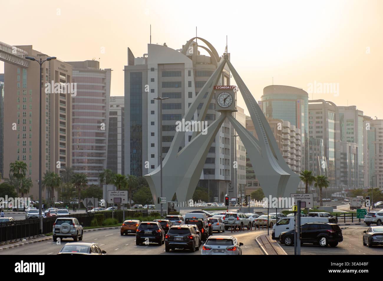 Vue surélevée de la circulation dense approchant le monument emblématique de la tour de l'horloge Deira au coucher du soleil à Dubaï, Émirats arabes Unis. Banque D'Images