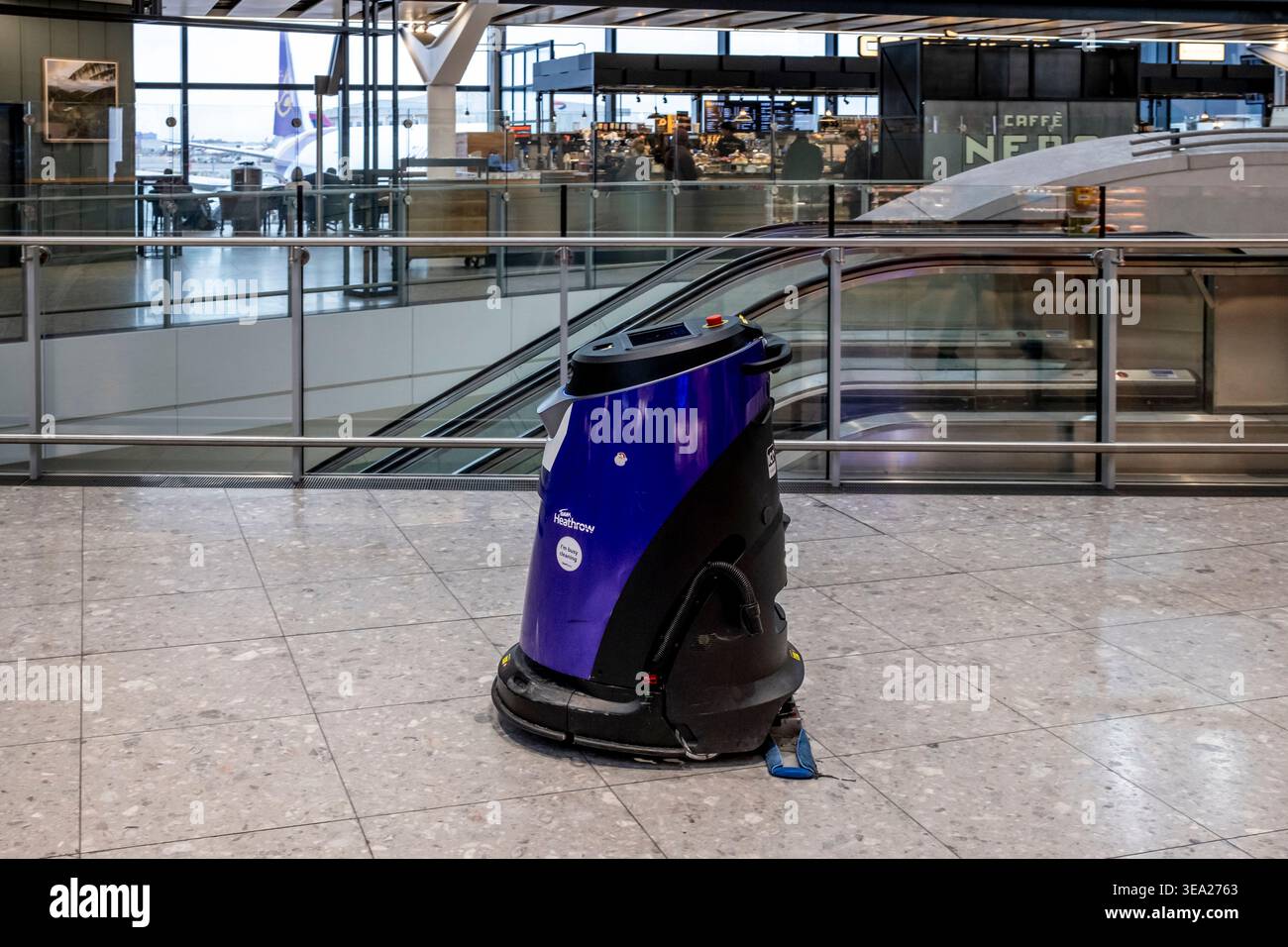 Robot autonome de nettoyage des sols, terminal 2, aéroport d'Heathrow, Londres, Royaume-Uni. Banque D'Images