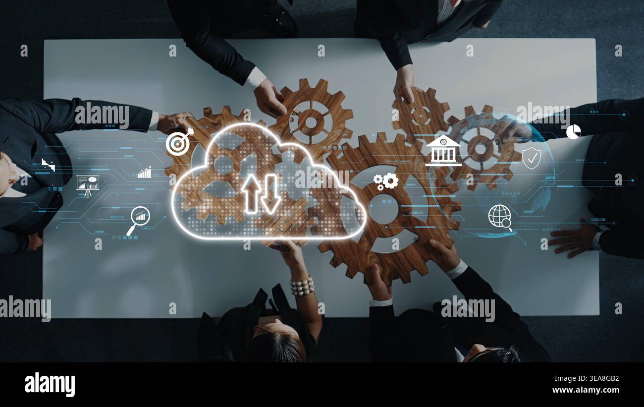 Une équipe dynamique collabore autour d'une table avec des engrenages représentant le flux de travail, mettant en valeur l'intégration de la technologie cloud et des stratégies innovantes Banque D'Images