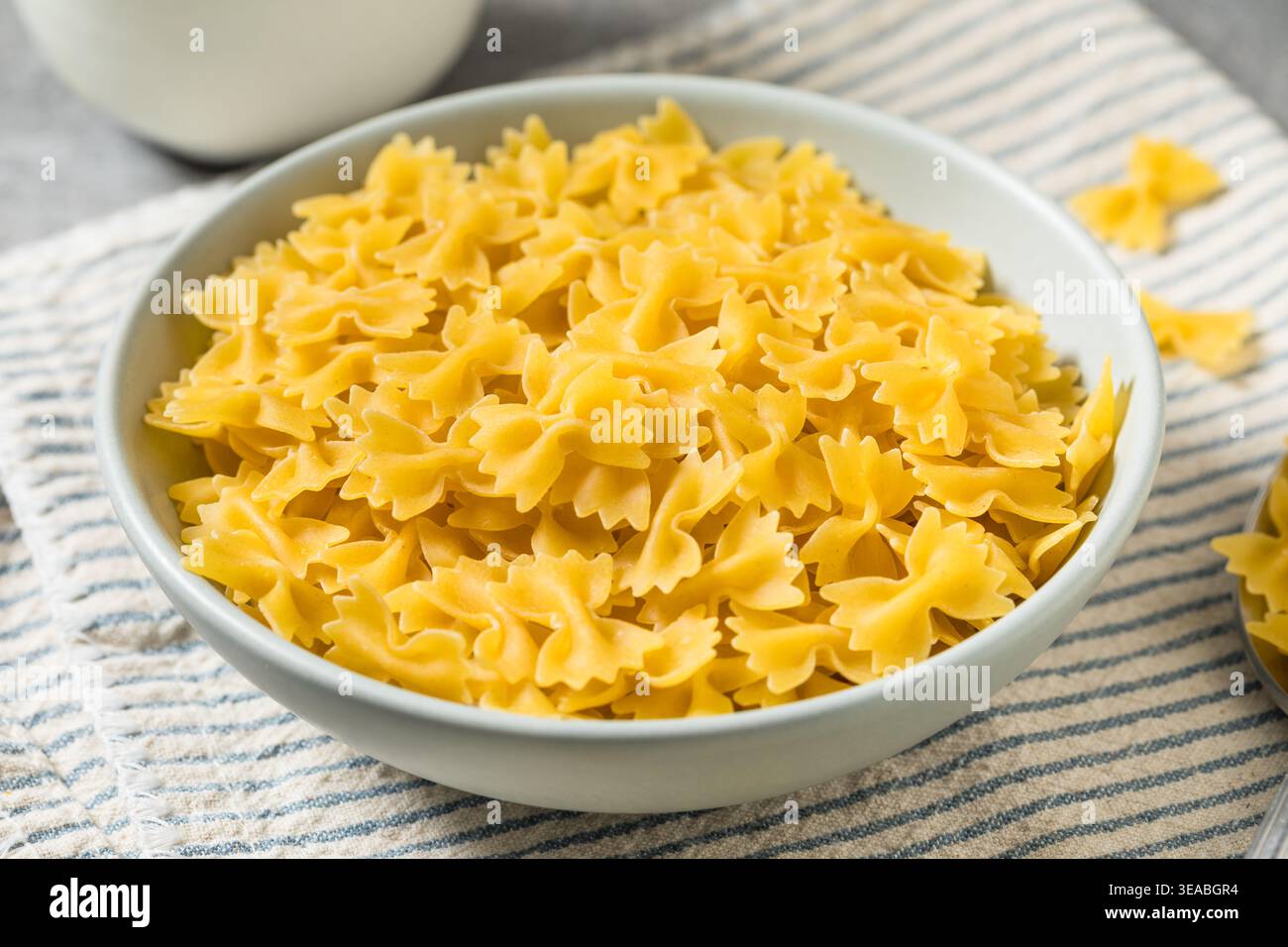 Pâtes biologiques à nouer au noeud au Mini Farfalle dans un bol Banque D'Images