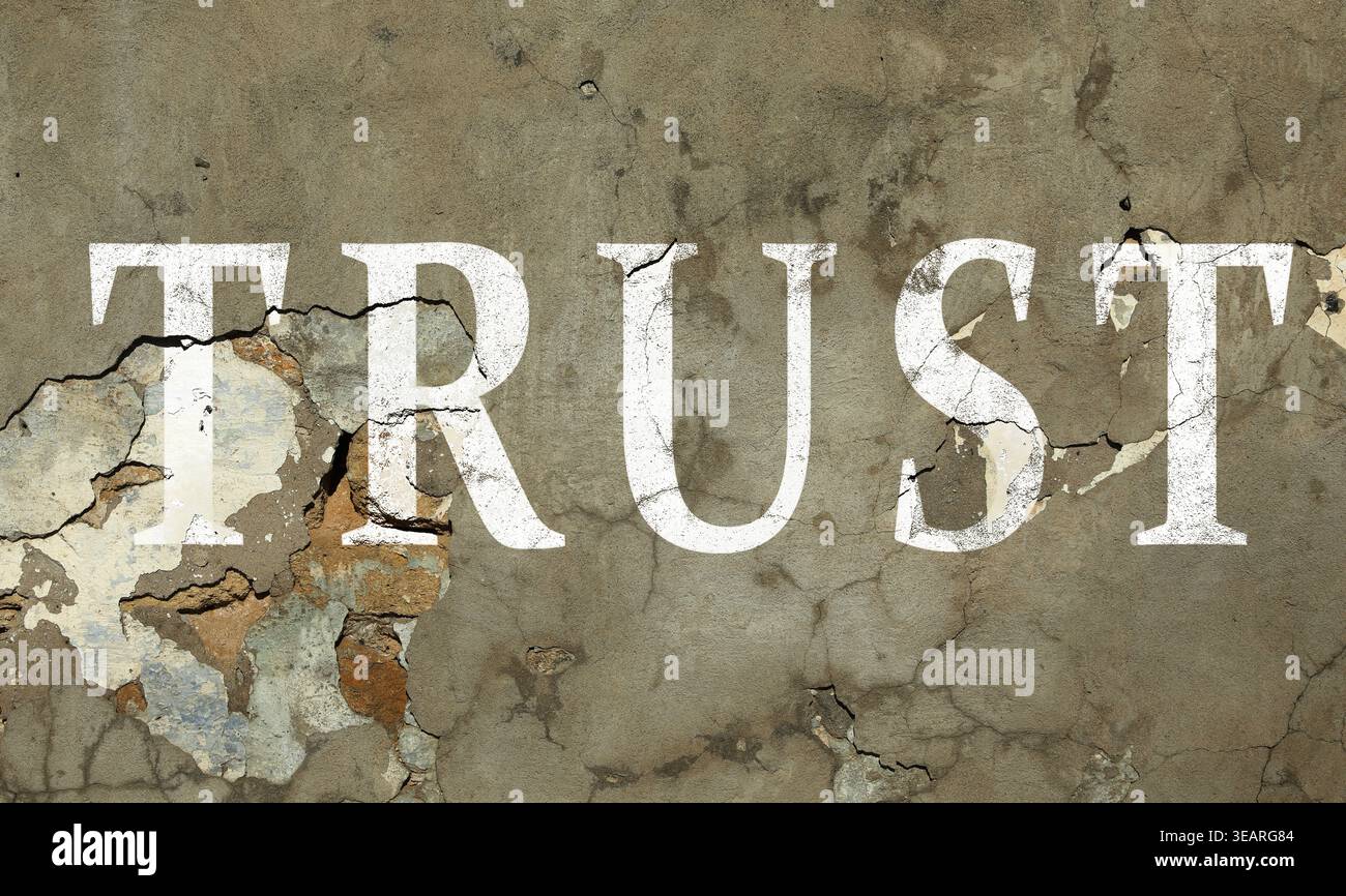 Word Trust et fissures sur le mur. Trahison Banque D'Images