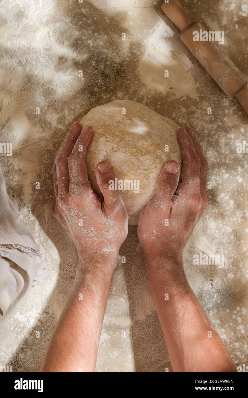 Chef pâtissier façonnant la boule de pâte pour l'épreuvage, mise au point calme Banque D'Images