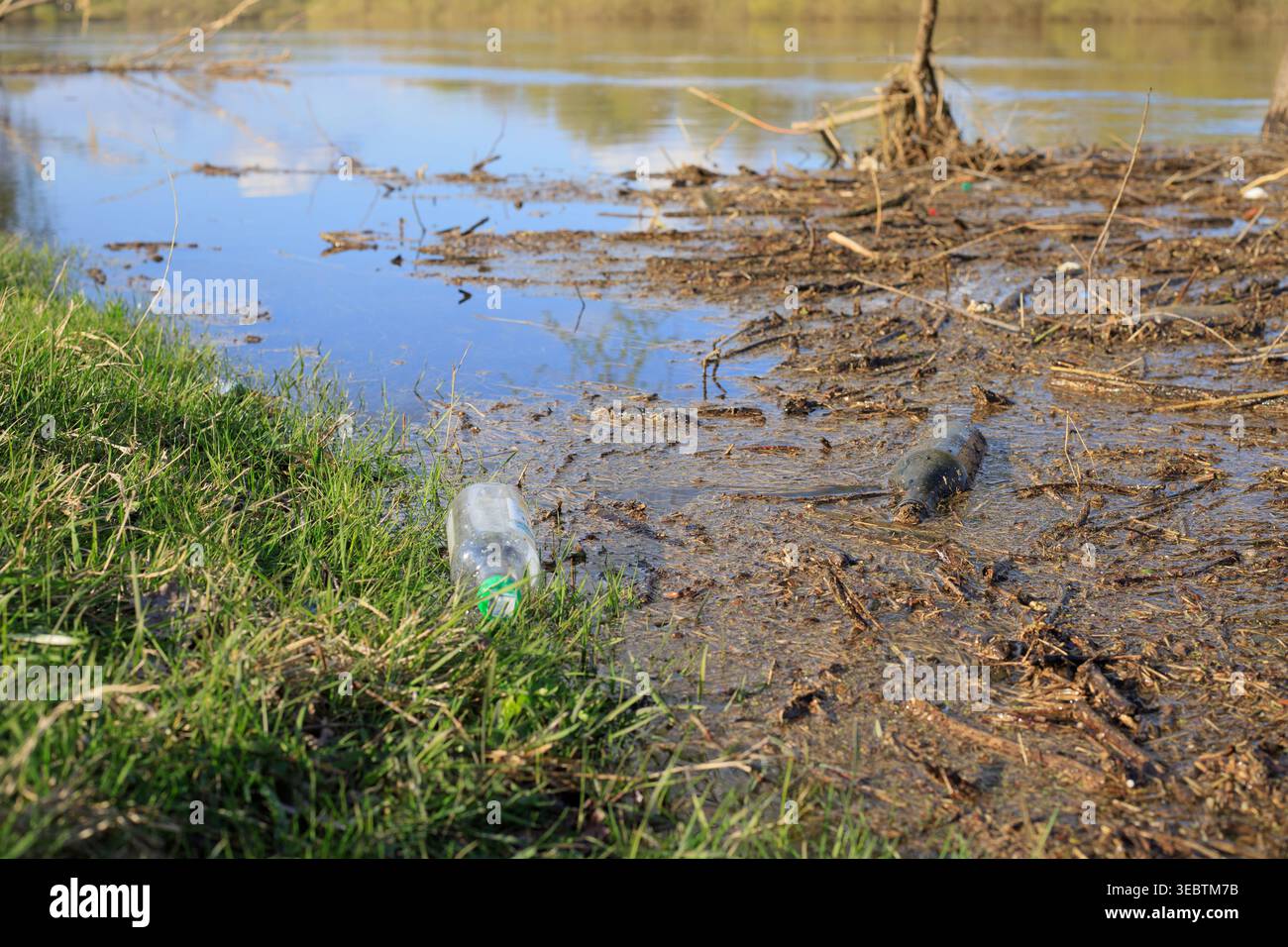Bouteilles en plastique et en verre en eau peu profonde. Concept de pollution humaine des rivières et des lacs. Déchets impactant la nature, les écosystèmes aquatiques et le purit Banque D'Images