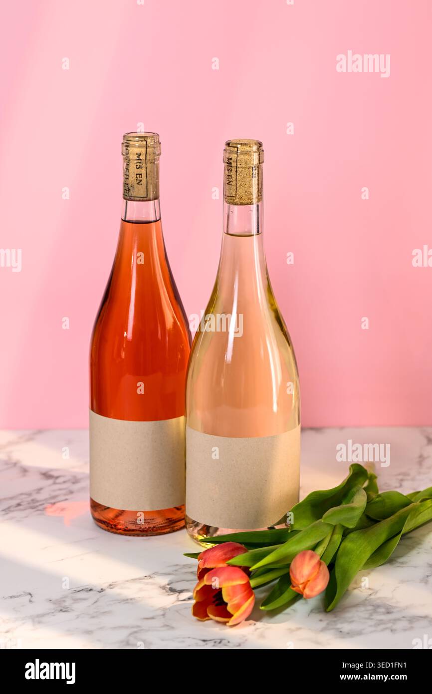 Deux bouteilles de vin et tulipes sur une surface en marbre Banque D'Images