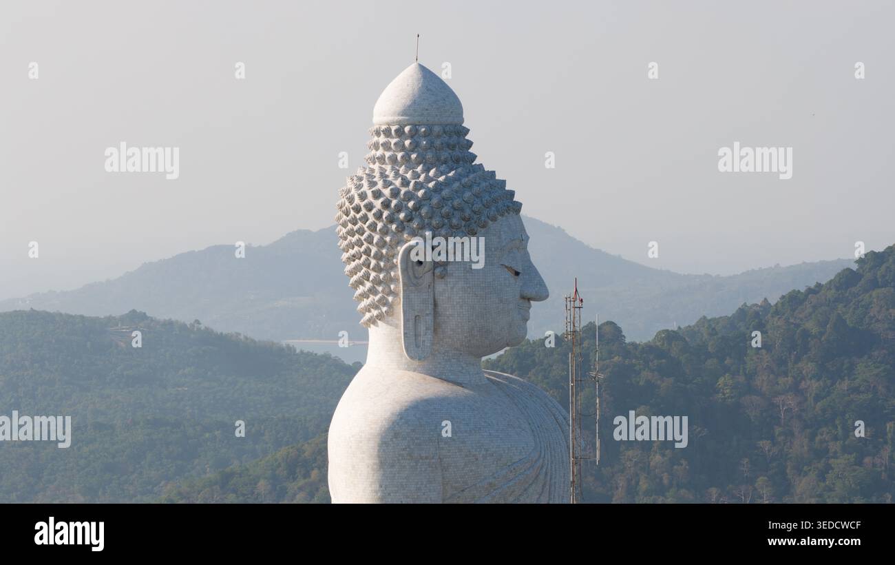 Vue aérienne de la majestueuse statue de Big Buddha de profil sur un fond de collines verdoyantes et un ciel brumeux à Tambon Karon, Chang Wat Phuket, Thai Banque D'Images