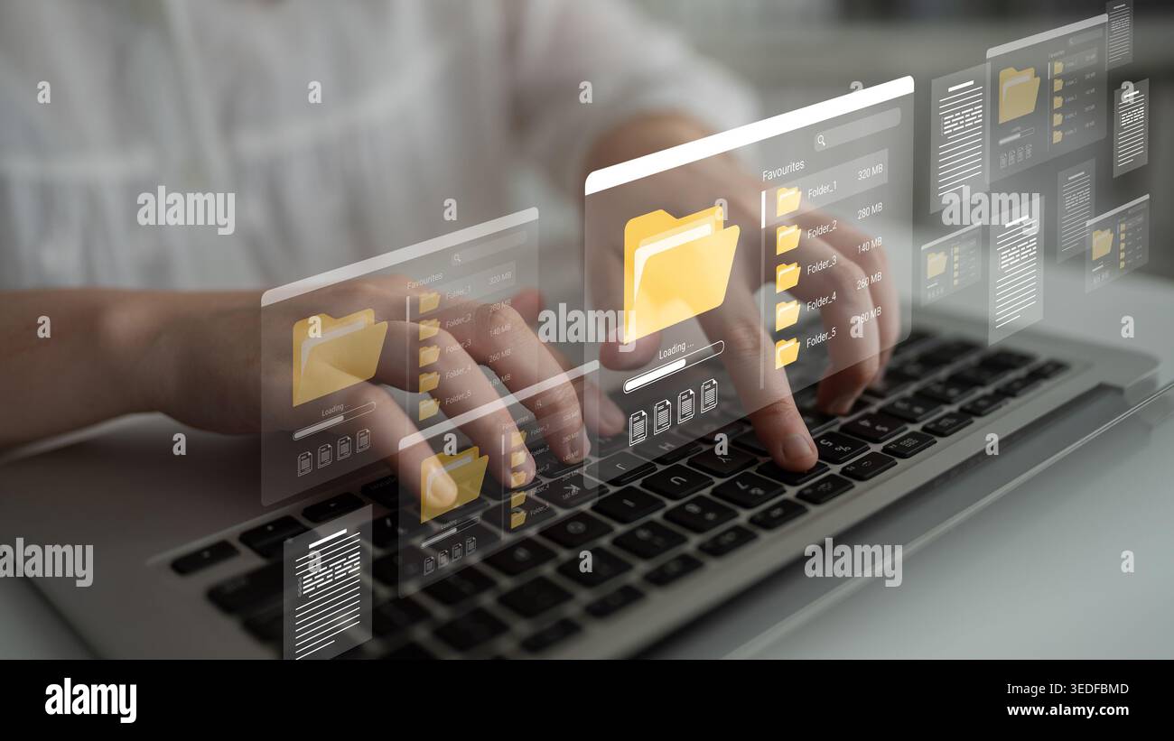 Une personne interagit avec un ordinateur portable, présentant une interface de gestion de fichiers numériques avancée avec des icônes de dossier, symbolisant la productivité moderne et Banque D'Images