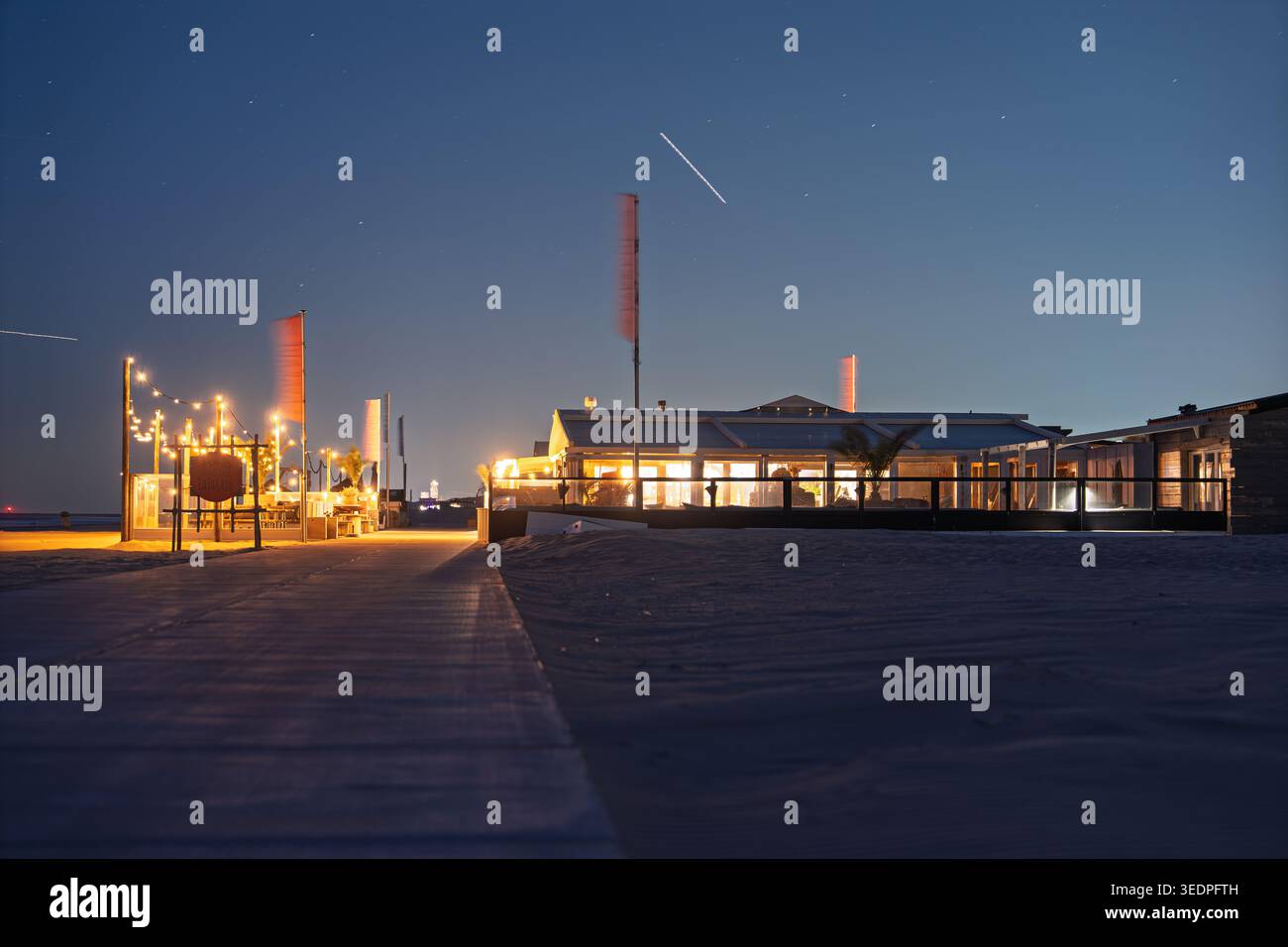 Vue en soirée d'un bar de plage et d'un restaurant la nuit avec passerelle éclairée vers le rivage en Australie méridionale Banque D'Images