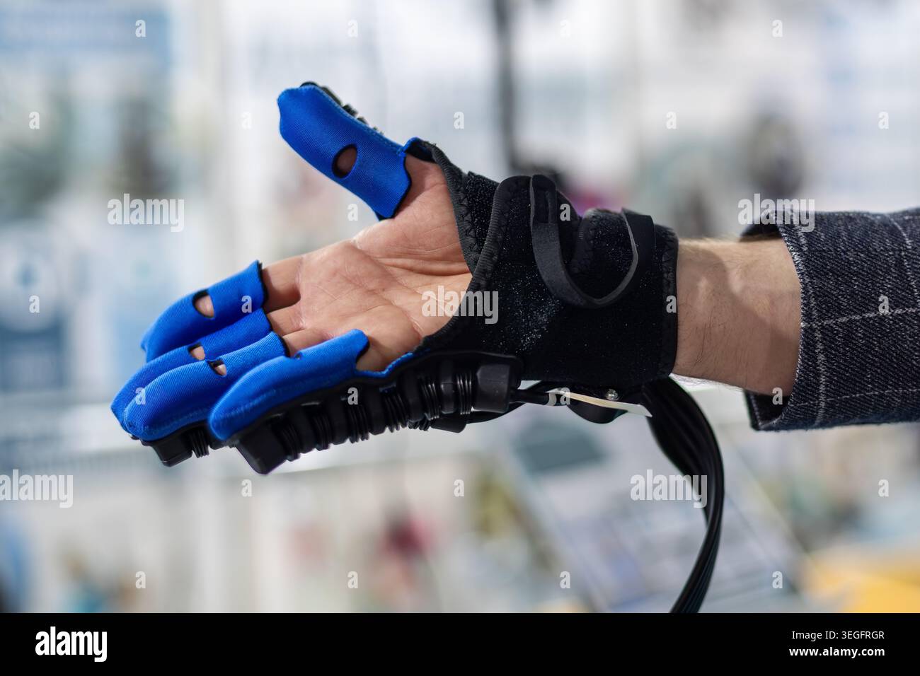 Gant de rééducation robotique aidant la main ouverte. Gros plan d'un gant de thérapie robotique supportant une main ouverte pour le mouvement des doigts, la rééducation et Banque D'Images