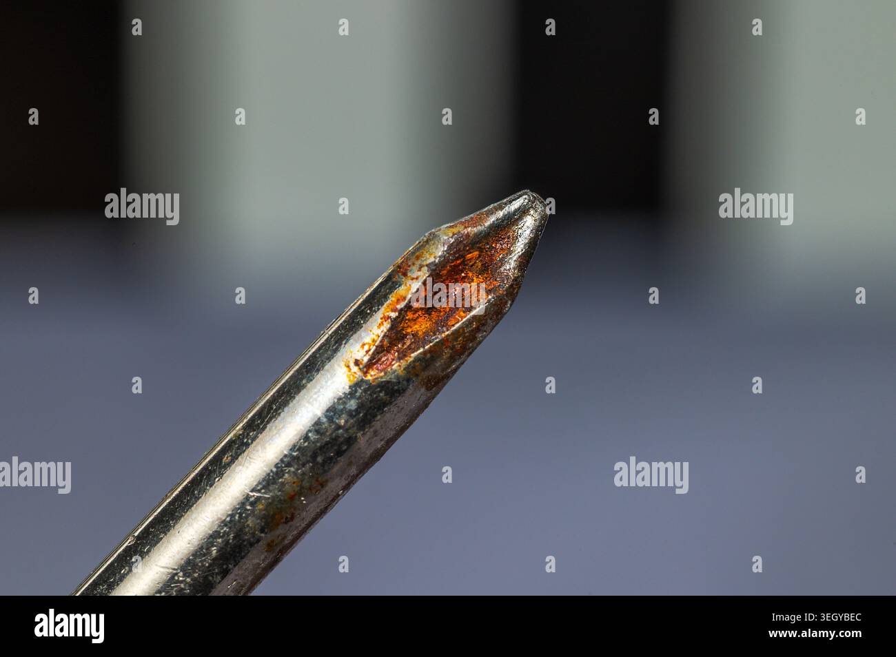 Gros plan macro d'une pointe de tournevis cruciforme rouillée montrant de la corrosion et de l'usure Banque D'Images