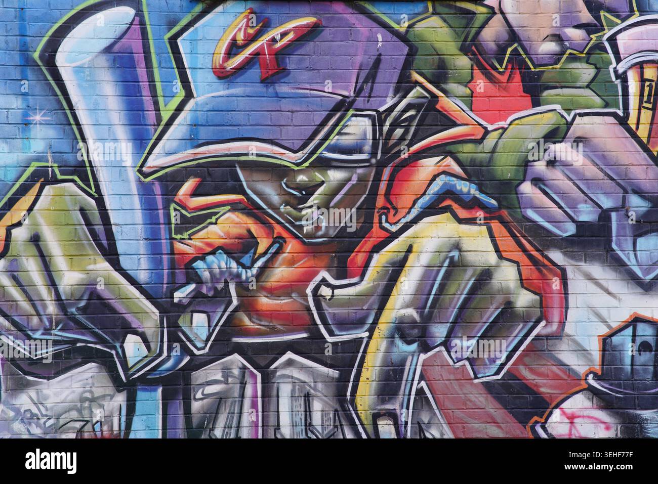 Peinture murale vibrante de joueur de baseball sur un mur de briques à Brighton, en Angleterre. Banque D'Images
