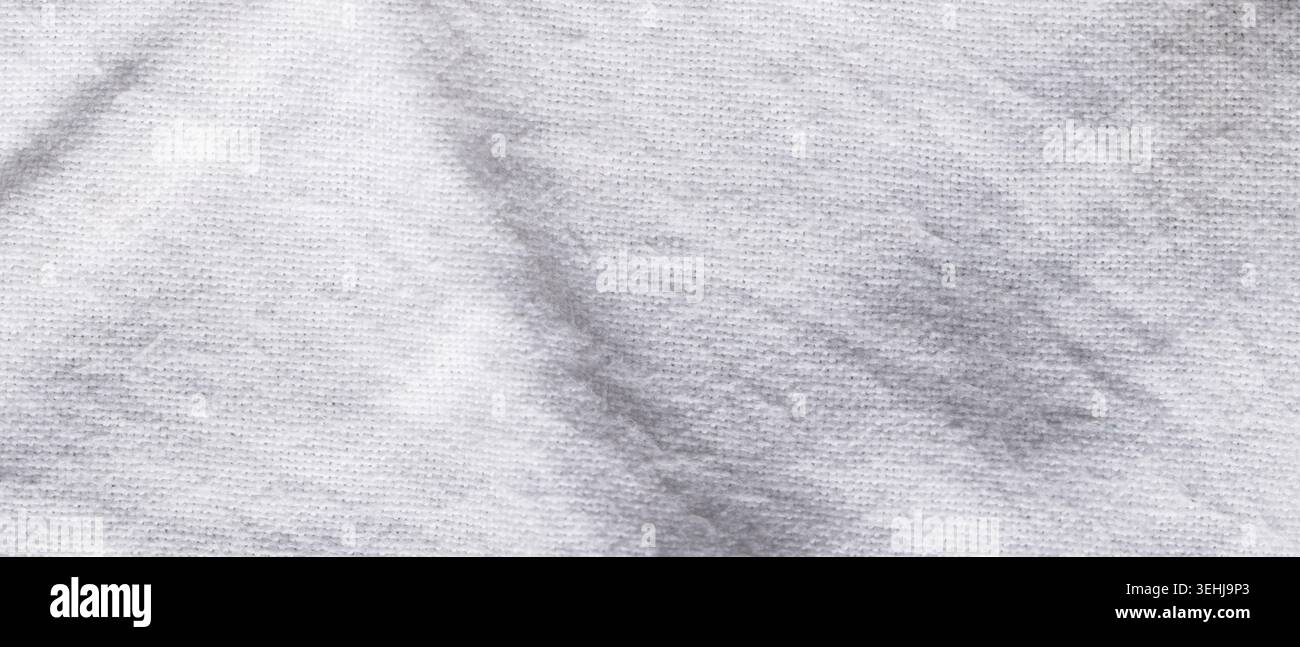 Texture de tissu tricoté blanc avec des taches grises naturelles Banque D'Images