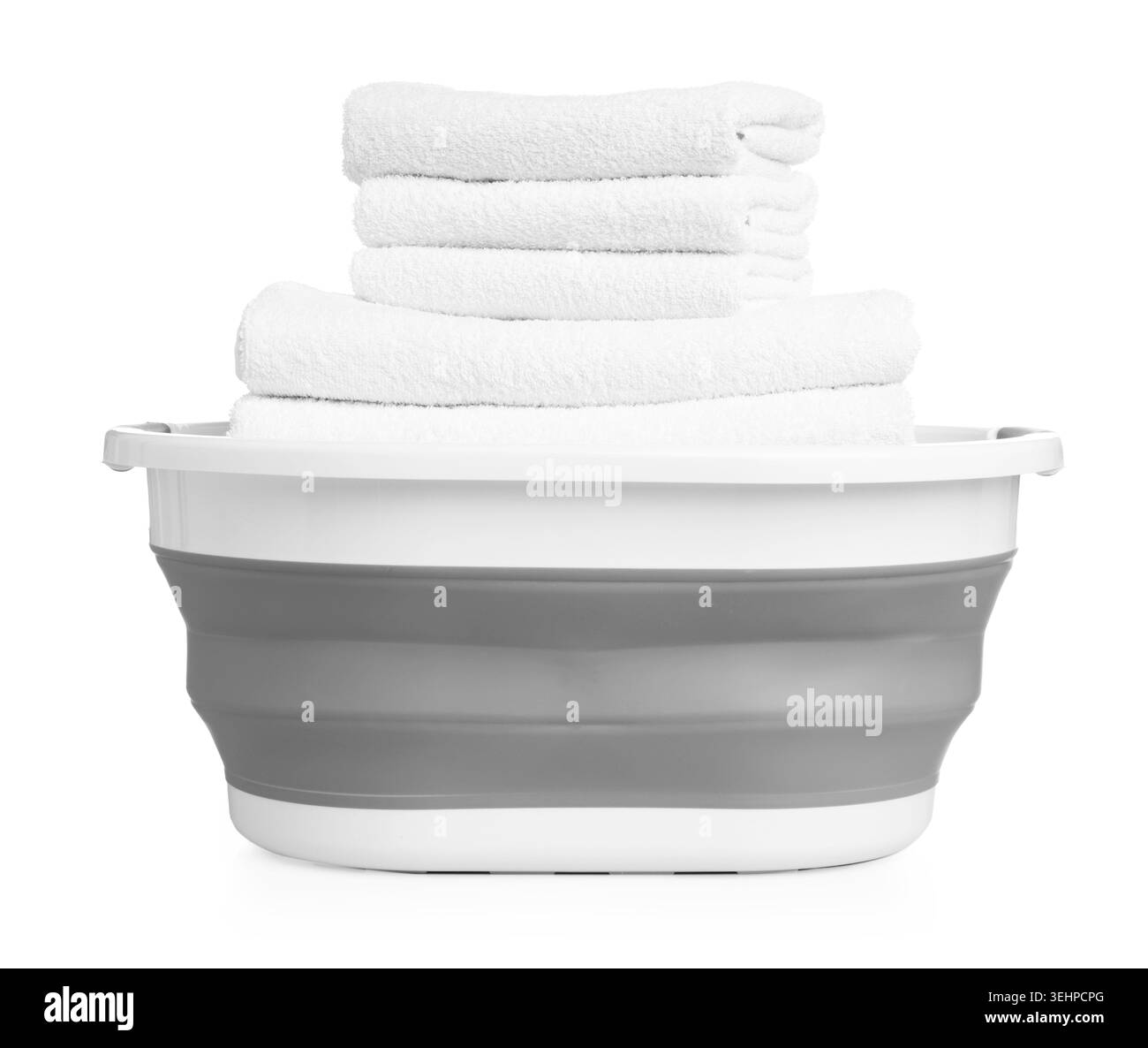 Beaucoup de serviettes propres douces dans le panier à linge isolé sur blanc Banque D'Images